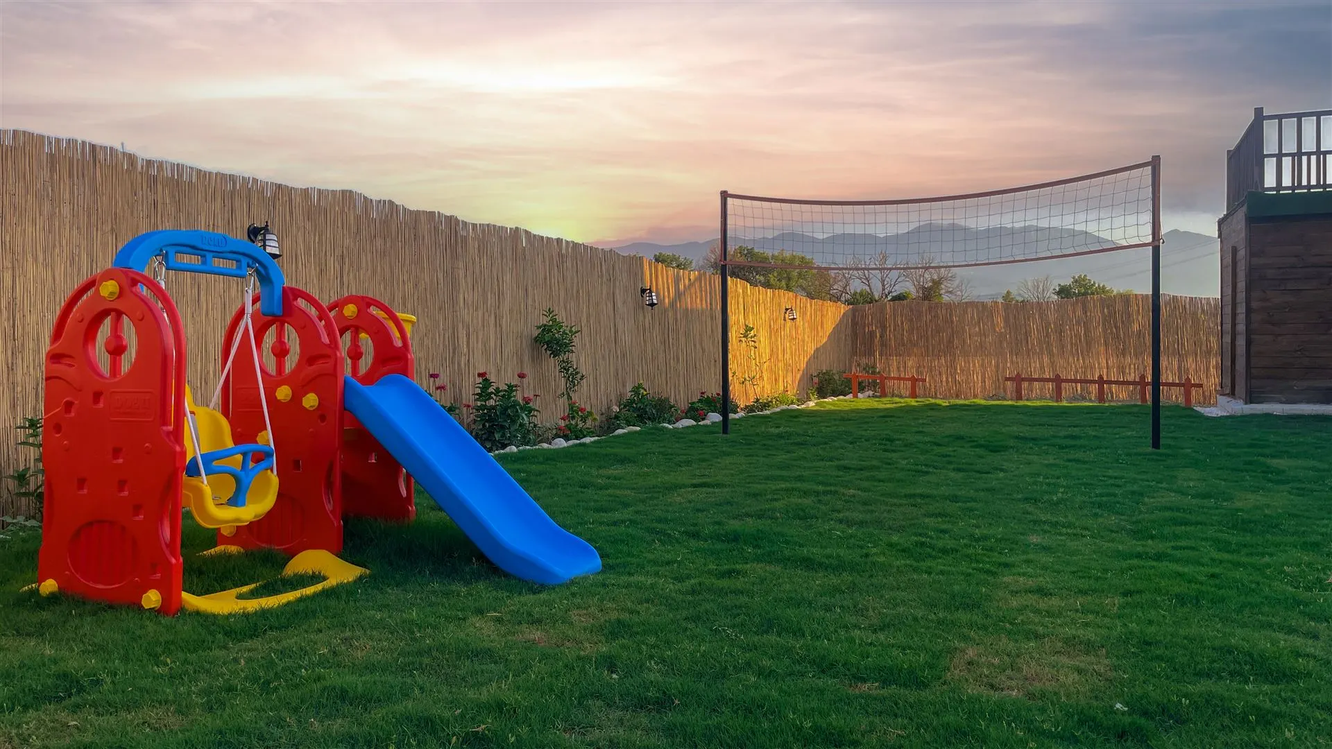 Kids' playground and volleyball court in the garden
